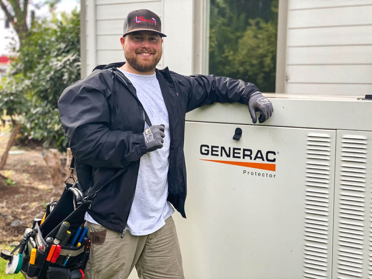 Service tech standing next to a generator